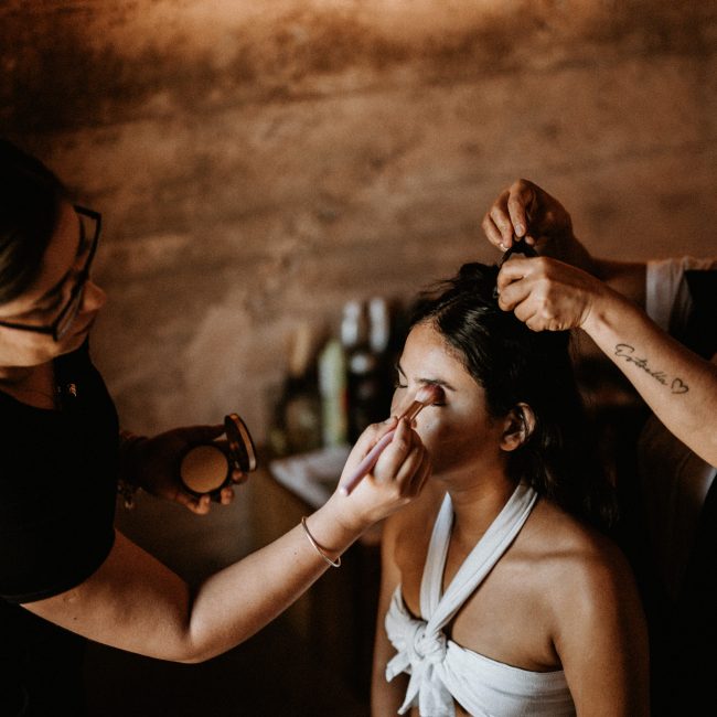 Styling Trio artists working on a bride’s hair and makeup